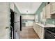 Spacious kitchen with stainless steel refrigerator, white cabinets, and views to the backyard at 1759 Michele Ln, Greenwood, IN 46142