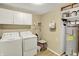 Bright laundry room with washer, dryer, and water heater at 1759 Michele Ln, Greenwood, IN 46142