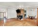 Open-concept living room featuring hardwood floors, a fireplace, and natural light from the glass front door at 1759 Michele Ln, Greenwood, IN 46142