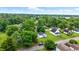 Aerial view of home with green surroundings, detached garage, and street view at 1933 Tallman Ave, Indianapolis, IN 46218