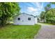 Backyard view of the home highlighting the white vinyl siding and gravel pathway at 1933 Tallman Ave, Indianapolis, IN 46218