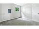 Neutral bedroom featuring carpet floors, a window overlooking green foliage, and a closet at 1933 Tallman Ave, Indianapolis, IN 46218