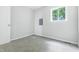 Bedroom with gray carpet, natural light, and a convenient electrical panel at 1933 Tallman Ave, Indianapolis, IN 46218