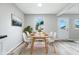 Well-lit dining room with modern decor, a dining table set for six, and luxury vinyl plank flooring at 1933 Tallman Ave, Indianapolis, IN 46218