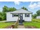 Charming one-story home with white siding, black shutters, and a well-maintained front yard at 1933 Tallman Ave, Indianapolis, IN 46218