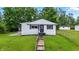 Charming home with sidewalk to entry and black shutters and door at 1933 Tallman Ave, Indianapolis, IN 46218