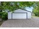 View of detached one car garage with white siding and black trim and fixtures at 1933 Tallman Ave, Indianapolis, IN 46218