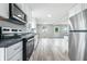 Modern kitchen with stainless steel appliances, bright white cabinetry, and durable countertops, blending style and functionality at 1933 Tallman Ave, Indianapolis, IN 46218