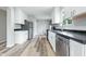 Modern kitchen features stainless steel appliances, white cabinetry, and durable countertops, designed for functionality and style at 1933 Tallman Ave, Indianapolis, IN 46218