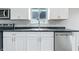 Updated kitchen with new stainless steel dishwasher and sink, bright white cabinets, and durable countertops at 1933 Tallman Ave, Indianapolis, IN 46218