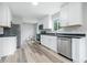 Modern kitchen with stainless steel appliances, bright white cabinetry, and stylish countertops, ready for culinary creations at 1933 Tallman Ave, Indianapolis, IN 46218