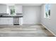 Well-lit kitchen boasts new stainless steel dishwasher, bright white cabinets, and durable countertops for easy cleanup at 1933 Tallman Ave, Indianapolis, IN 46218