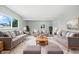 Bright, spacious living room with comfortable seating, a large window, and a plush rug at 1933 Tallman Ave, Indianapolis, IN 46218