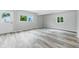 Bright living area featuring luxury vinyl plank flooring, neutral walls, and natural light from multiple windows at 1933 Tallman Ave, Indianapolis, IN 46218