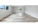 Light and airy living space with luxury vinyl plank flooring, neutral walls, and a bright atmosphere at 1933 Tallman Ave, Indianapolis, IN 46218