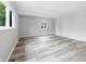 Open living area featuring neutral walls, luxury vinyl plank flooring, and ample natural light at 1933 Tallman Ave, Indianapolis, IN 46218