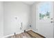 Utility room featuring a back door and plumbing fixtures and vinyl flooring at 1933 Tallman Ave, Indianapolis, IN 46218