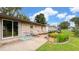 Charming outdoor patio with seating, landscaped garden beds, and sliding glass door access at 202 Collier St, Columbus, IN 47201