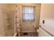 Clean bathroom with a shower-tub combo and floral curtain, offering a functional and refreshing space with updated fixtures at 202 Collier St, Columbus, IN 47201