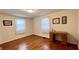 Inviting bedroom with natural hardwood floors, vintage desk, and ample sunlight, creates a flexible and restful space at 202 Collier St, Columbus, IN 47201