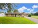 Charming single-story home with well-maintained lawn and inviting curb appeal, featuring a convenient attached garage at 202 Collier St, Columbus, IN 47201