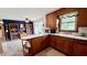 Charming kitchen with wood cabinets, marble-look countertops, and backyard view at 202 Collier St, Columbus, IN 47201