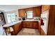 Well-maintained kitchen with light countertop, wood cabinetry, and stainless steel sink at 202 Collier St, Columbus, IN 47201
