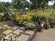 Beautifully landscaped garden featuring stone pavers and a variety of colorful plants, ideal for outdoor relaxation at 202 Collier St, Columbus, IN 47201