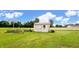 Exterior view of a shed featuring a garden with a decorative fence, providing ample storage space and enhancing the backyard at 202 Collier St, Columbus, IN 47201