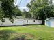 Exterior view of the home showcasing the backyard and separate garage at 221 N 9Th St, Elwood, IN 46036