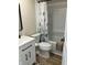 Neutral bathroom offers a tub-shower combo with a decorative shower curtain, a modern vanity and a toilet at 221 N 9Th St, Elwood, IN 46036