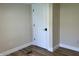 Neutral-toned bedroom features wood-look floors, a door, and white trim for a simple, clean aesthetic at 221 N 9Th St, Elwood, IN 46036