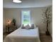 Well-lit bedroom with wood-look floors, large window, and simple decor, creating a comfortable space at 221 N 9Th St, Elwood, IN 46036