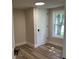 Cozy bedroom with ample natural light, showcasing a door, a window with trim and neutral walls at 221 N 9Th St, Elwood, IN 46036