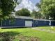 Rear exterior showcasing the home's blue siding, well-maintained yard, and attached garage for ample parking at 221 N 9Th St, Elwood, IN 46036