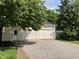 Detached two car garage with white doors, siding, and a gravel driveway at 221 N 9Th St, Elwood, IN 46036