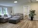 Cozy living room seamlessly connects to the bedroom, featuring wood-look floors and neutral decor at 221 N 9Th St, Elwood, IN 46036