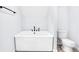 A bright bathroom features a white soaking tub with modern, matte black fixtures and a white toilet at 3035 Guilford Ave, Indianapolis, IN 46205