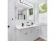 Bright bathroom showcasing a double sink vanity, modern fixtures, and natural light from the window at 3035 Guilford Ave, Indianapolis, IN 46205