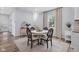 Stylish dining area with a round table set, complemented by light blue walls and natural light from the windows at 3035 Guilford Ave, Indianapolis, IN 46205