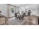 Cozy dining room featuring a round table and chairs with modern stainless steel appliances in the kitchen at 3035 Guilford Ave, Indianapolis, IN 46205