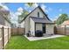 Well-kept home exterior with a manicured lawn, backyard patio, and black accents at 3035 Guilford Ave, Indianapolis, IN 46205