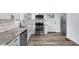 Updated kitchen features stainless steel appliances, granite countertops, and white cabinets at 3035 Guilford Ave, Indianapolis, IN 46205