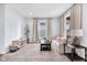 Well-lit living room features comfortable seating, stylish décor, and hardwood flooring at 3035 Guilford Ave, Indianapolis, IN 46205
