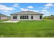 Backyard view of the house with lush green lawn and ample space, great for outdoor activities at 3072 W Glacier Dr, Monrovia, IN 46157