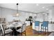 Open concept kitchen and dining area features hardwood floors, white cabinetry, and stainless steel appliances at 3072 W Glacier Dr, Monrovia, IN 46157