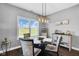 Dining area with natural light, modern light fixture, and a glass-top table at 3072 W Glacier Dr, Monrovia, IN 46157