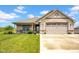 Charming brick home featuring a manicured lawn, covered porch, and an attached two-car garage at 3072 W Glacier Dr, Monrovia, IN 46157