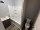 This bathroom features a shower/tub combo and a dark vanity at 3127 E Lynn St, Anderson, IN 46016