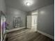 This bedroom has wood floors and gray walls with white trim at 3127 E Lynn St, Anderson, IN 46016